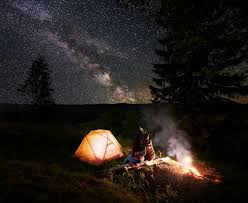 Adam Cherrington sitting by the crackling campfire